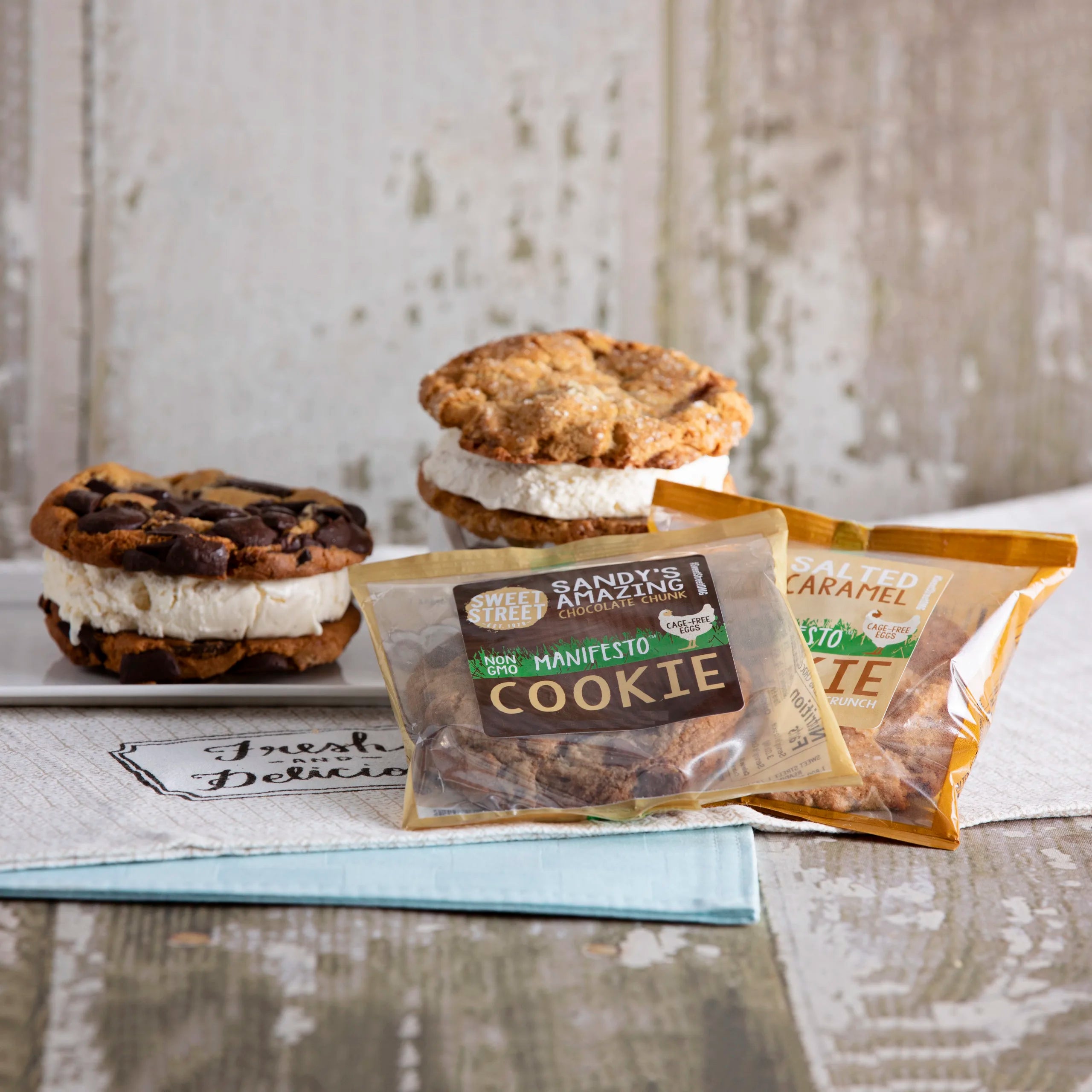 Ice cream sandwiches with cookie bases on a rustic wooden surface